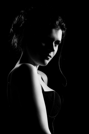 87287170 beautiful sad young woman on black background looking at camera monochrome atraso menstrual lima